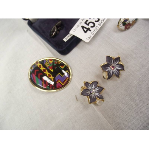 453 - A pair of silver and onyx cufflinks, an enamel brooch and 3 pairs of enamel earrings