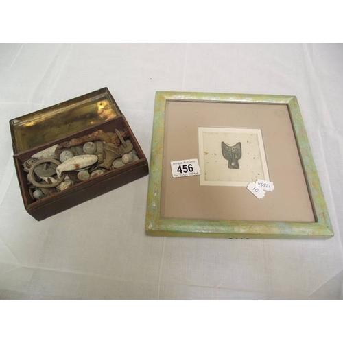 456 - A framed and glazed Chinese ancient style coin Bu Bi and a tin of relics