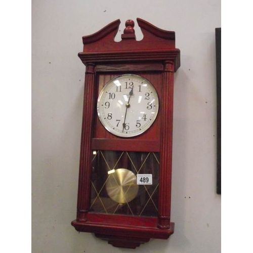 489 - A constant red wood stained quartz wall clock