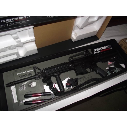 497 - A boxed Airsoft SOPMODM4 gun by Tokyo Marui Co Ltd. Please note magazine clip is missing and would n... 