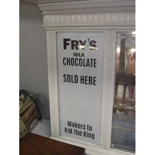 506 - A bevel edge mirror with painted frame and Frys Cocoa advertising to sides.  Mirror in poor conditio... 