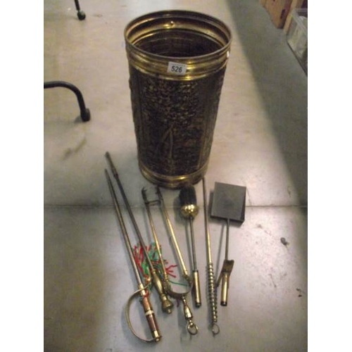 526 - A pressed brass stick stand with contents.