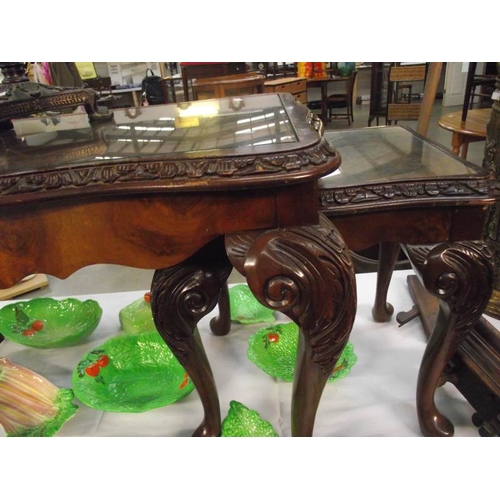 529 - A dark wood nest of 3 tables with glass tops.