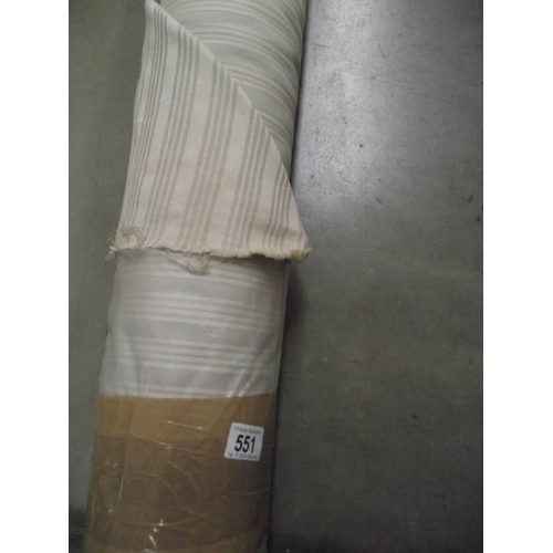 551 - A full roll of fabric, lenght unknown but may be 20 metres and the outer wrapper reads 20.