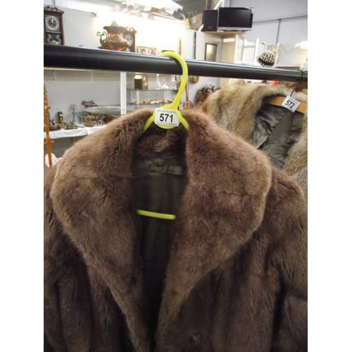 571 - A fur coat.  (repairs to lining, otherwise good).