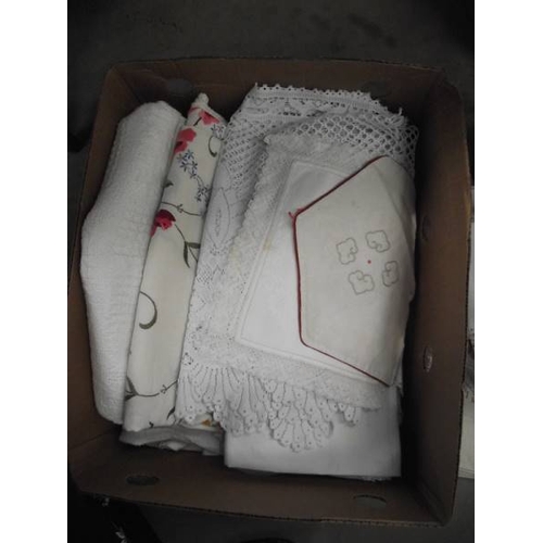 590A - A box of mixed linen/fabric including crocheted doilies etc.,