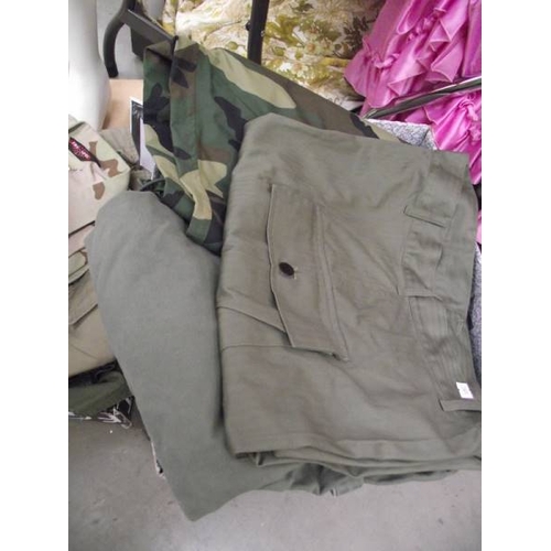 595 - A quantity of military clothing, BB airgun magazines etc.,