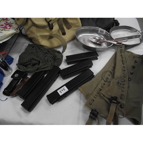 595 - A quantity of military clothing, BB airgun magazines etc.,