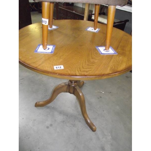 612 - A solid oak tripod table.