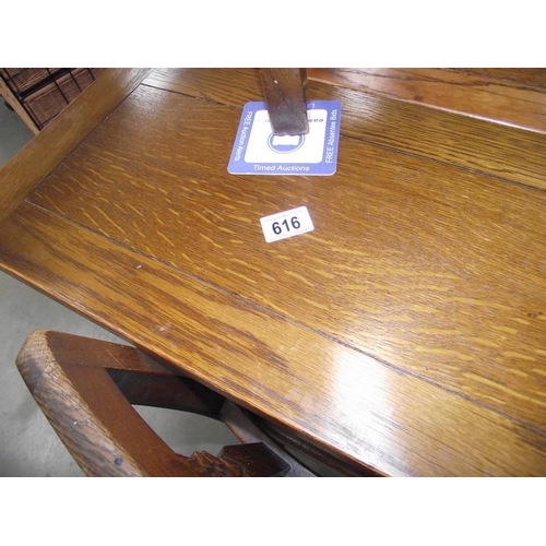 616 - A 1950's oak draw leaf table with 4 chairs.