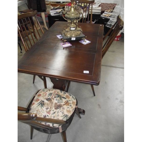 619 - A dark oak draw leaf table and 4 Ercol chairs.