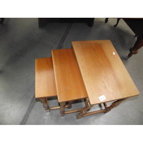 620 - A nest of 3 teak tables.