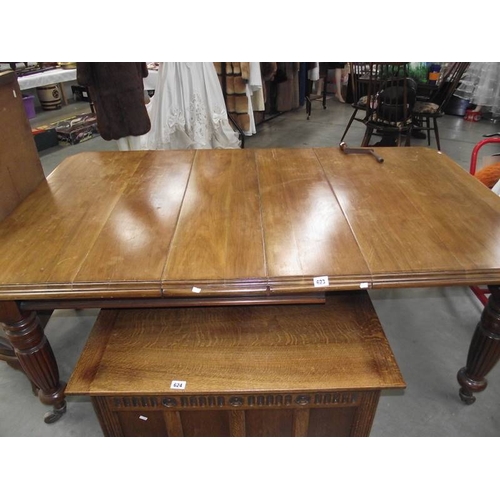 623 - A Victorian mahogany wind out table with 2 leaves.