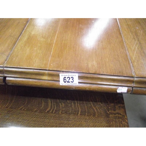 623 - A Victorian mahogany wind out table with 2 leaves.