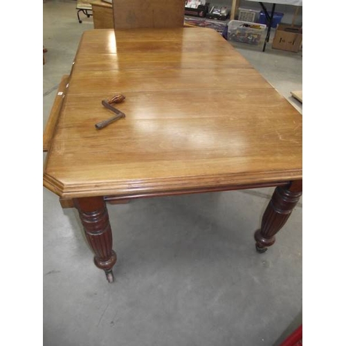 623 - A Victorian mahogany wind out table with 2 leaves.