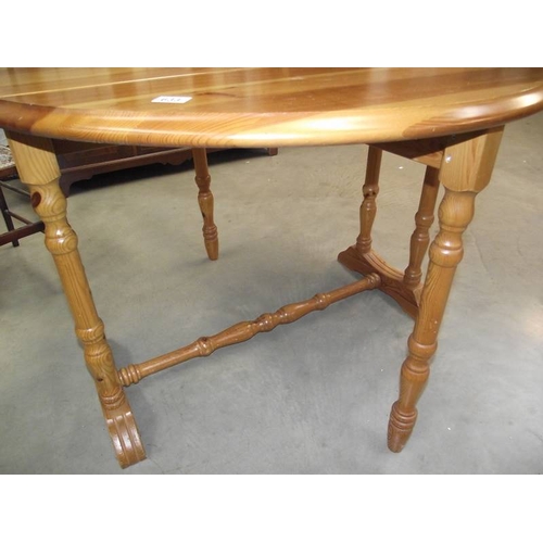 633 - A solid pine gate leg kitchen table.