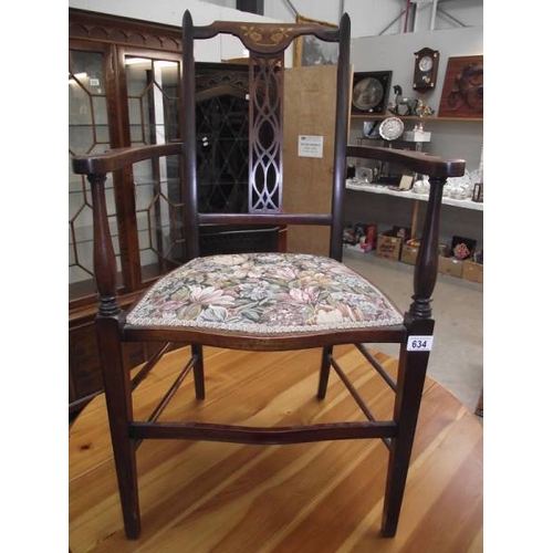 634 - An Edwardian inlaid elbow chair.