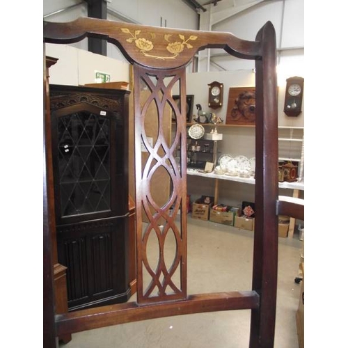 634 - An Edwardian inlaid elbow chair.