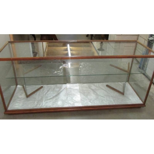 690 - A glass shop cabinet.  61'' long x 19.5'' deep x 25'' tall,  frame work needs attention but otherwis... 