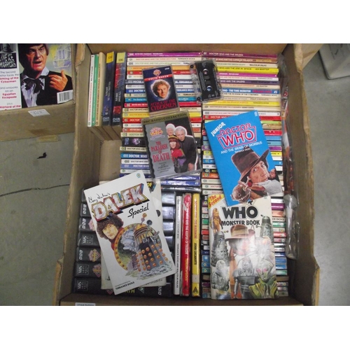 302 - 4 boxes of Doctor Who books. jigsaws, magazines etc.,