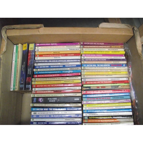 302 - 4 boxes of Doctor Who books. jigsaws, magazines etc.,