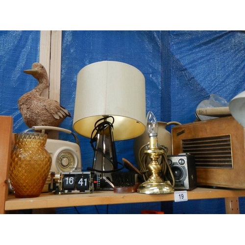 19 - A shelf of radio's, lamp etc.,