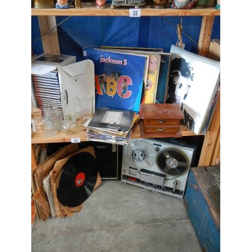 23 - An old tape recorder and 2 shelves of records.