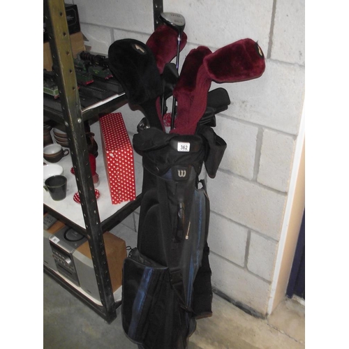 362 - A caddy bag with golf clubs including Wilson