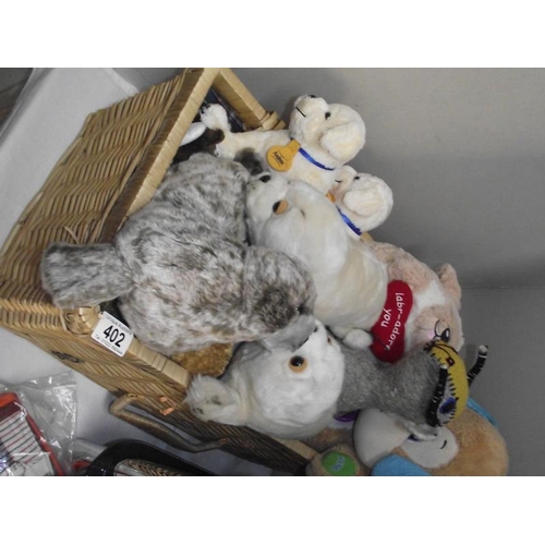 402 - A quantity of stuffed toys including Andrex puppies in wicker basket