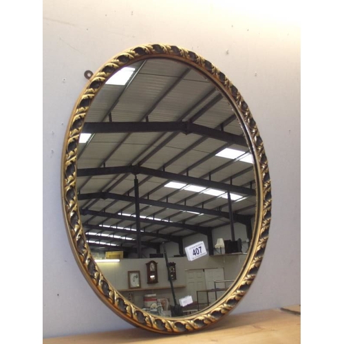 407 - A gilt framed oval mirror