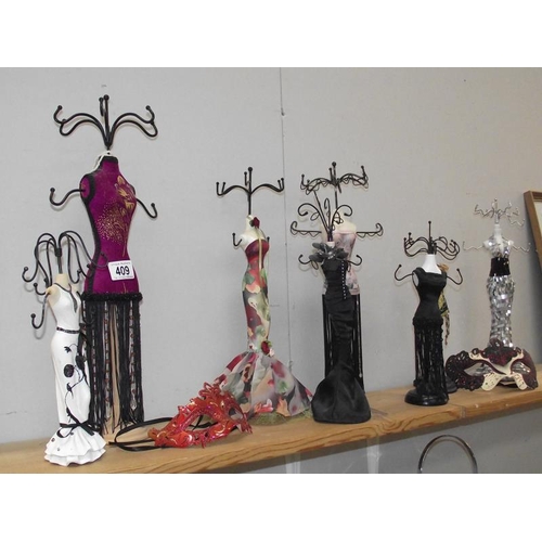 409 - A good selection of figural jewellery stands