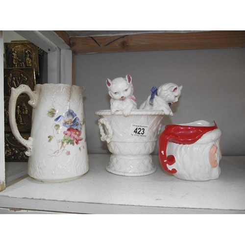 423 - A father Christmas character jug, cats in a basket and floral jug all a/f