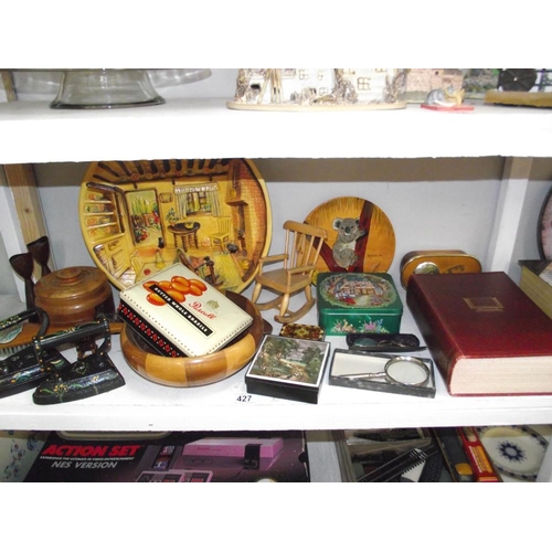 427 - A shelf of misc. wooden items, tins, flat irons etc.