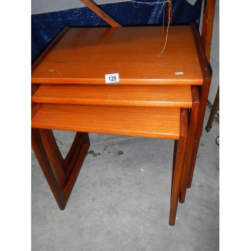 129 - A nest of 3 teak tables.