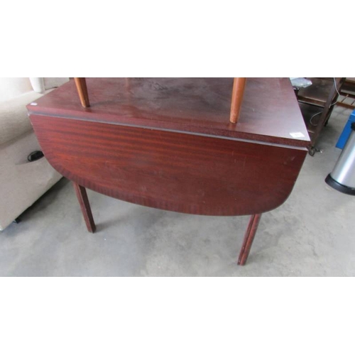 71 - A teak drop leaf table.