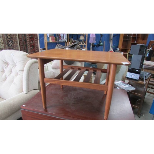 72 - A teak side table.