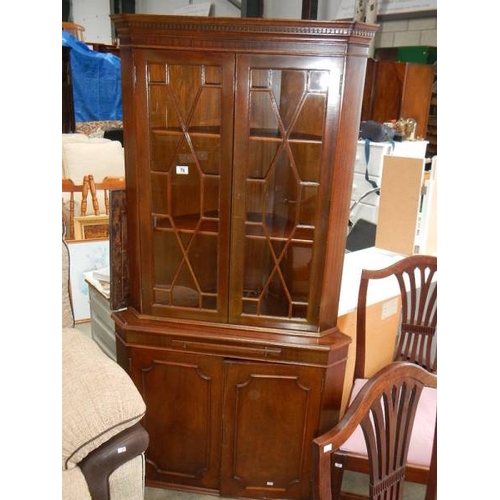 76 - An astragal glazed corner cabinet.