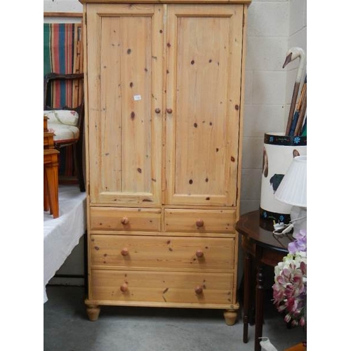 158 - A pine linen press with 2 doors and 2 over 2 drawer base.