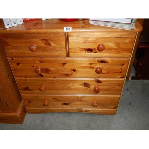 164 - A pine 2 over 3 chest of drawers.