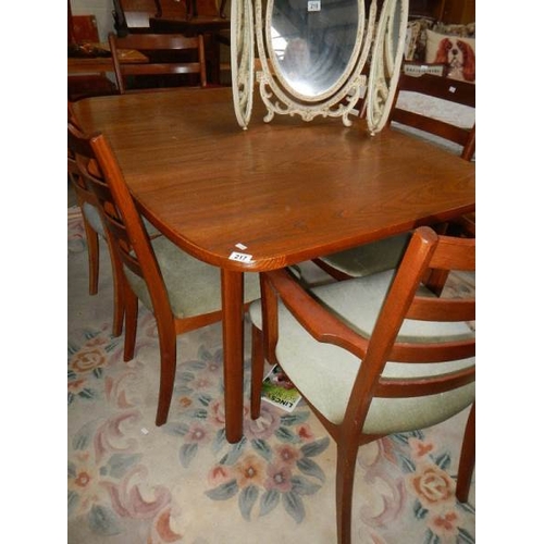 217 - A good oak dining table and 6 chairs.