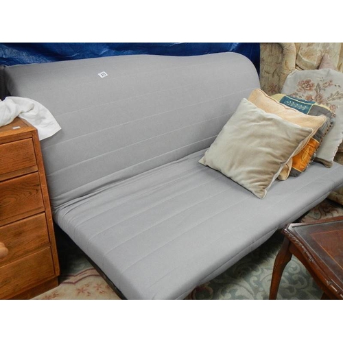 235 - A futon with dark blue cover and cushions.