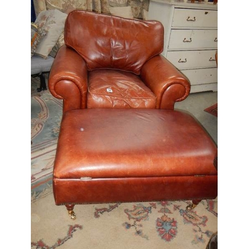 240 - A good leather arm chair and an ottoman.