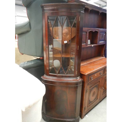 256 - A mahogany corner cupboard.