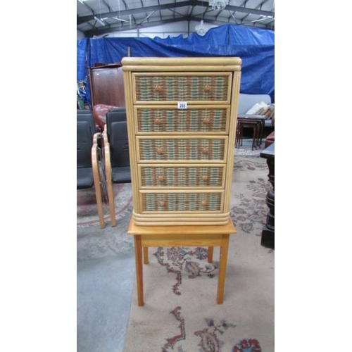 288 - A small wicker 5 drawer chest on stand.