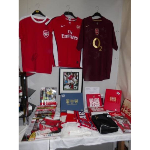 484 - A collection of Arsenal memorabilia including team shirt, signed shirt, A Thierry Henry shirt (as se... 