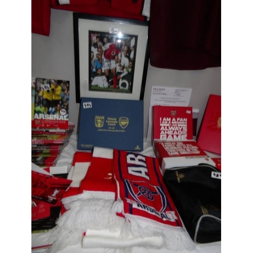 484 - A collection of Arsenal memorabilia including team shirt, signed shirt, A Thierry Henry shirt (as se... 