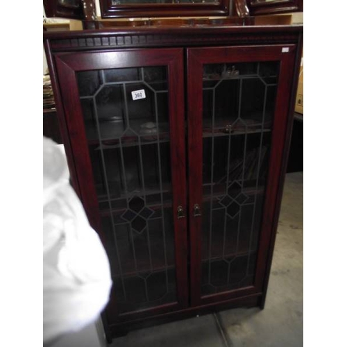 360 - A dark wood stained display cabinet  with leaded glass doors.