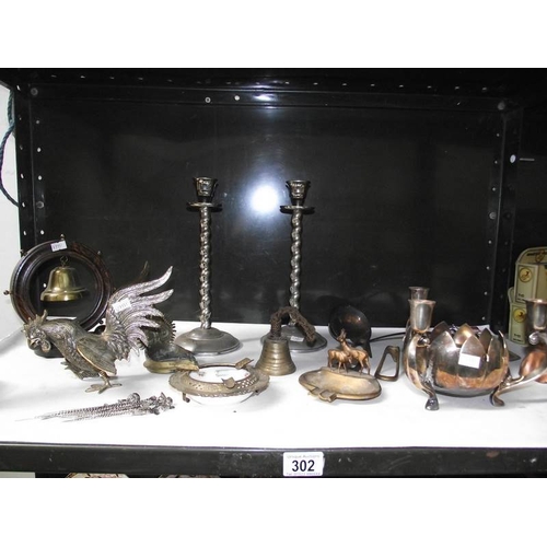 302 - A shelf of assorted metalware including Austrian spelter deer, Indian brassware, silver plate candle... 