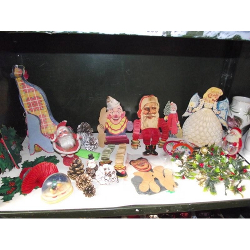 309 - 4 shelves of Christmas decorations including vintage.