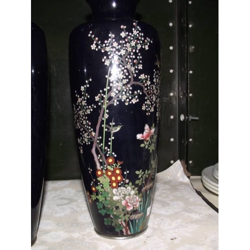 319 - A pair of hand painted metal vases, (one a/f).